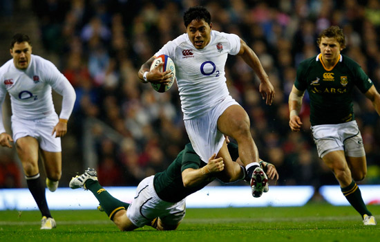 Man being tackled in a game of rugby.