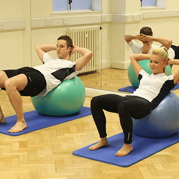 Yoga ball being used during a one-to-one pilates session