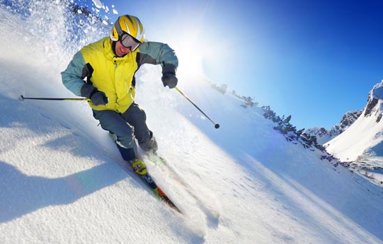 Skier deep within mountain snow.